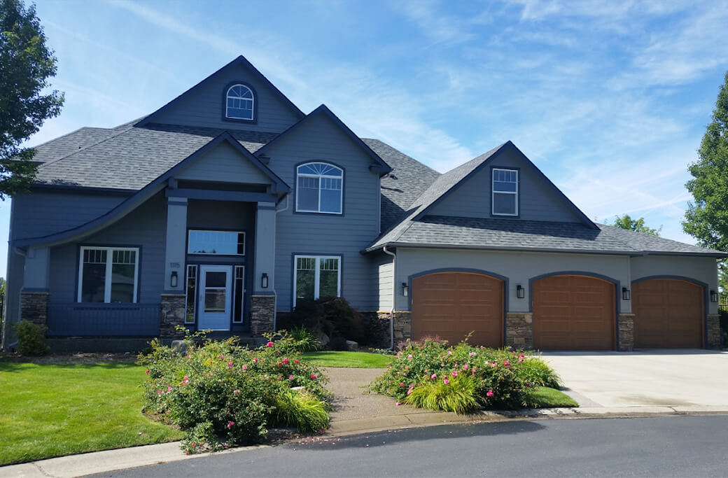 Finished residential exterior by GB Painting with dark siding